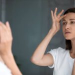 Botox not lasting in Reno patient examining forehead lines