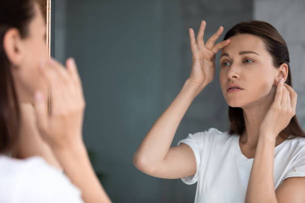 Botox not lasting in Reno patient examining forehead lines